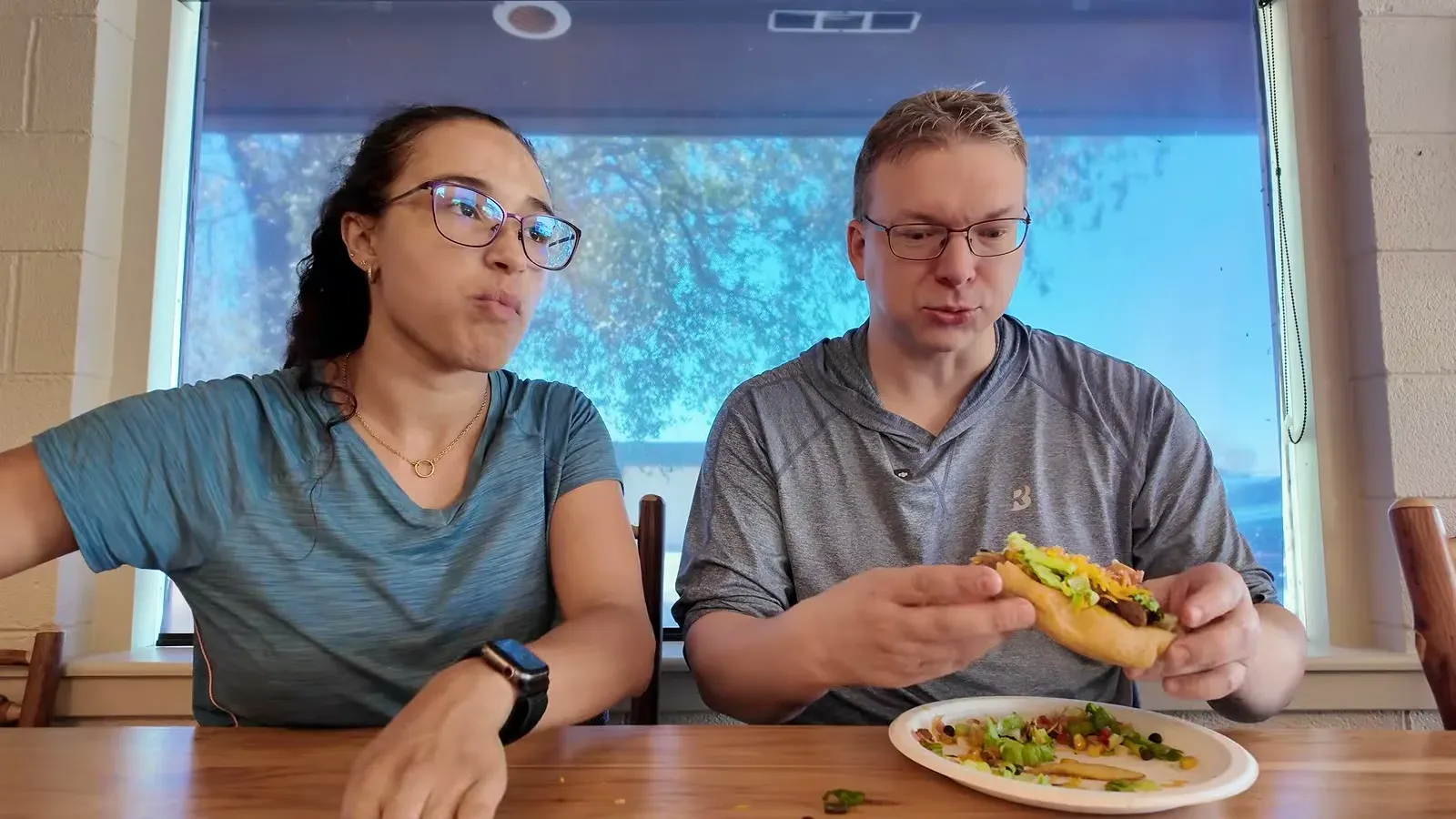 Nathan and Fabiola at a table with a bison Indian taco on fried bread at the Badlands campground restaurant