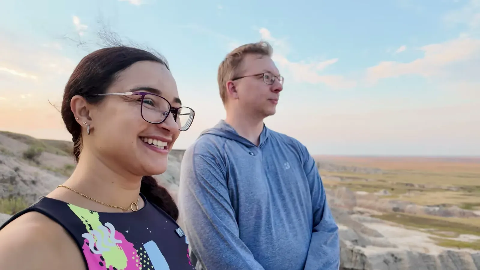 Nathan and Fabiola standing on the Badlands rim at sunset near our boondocking spot