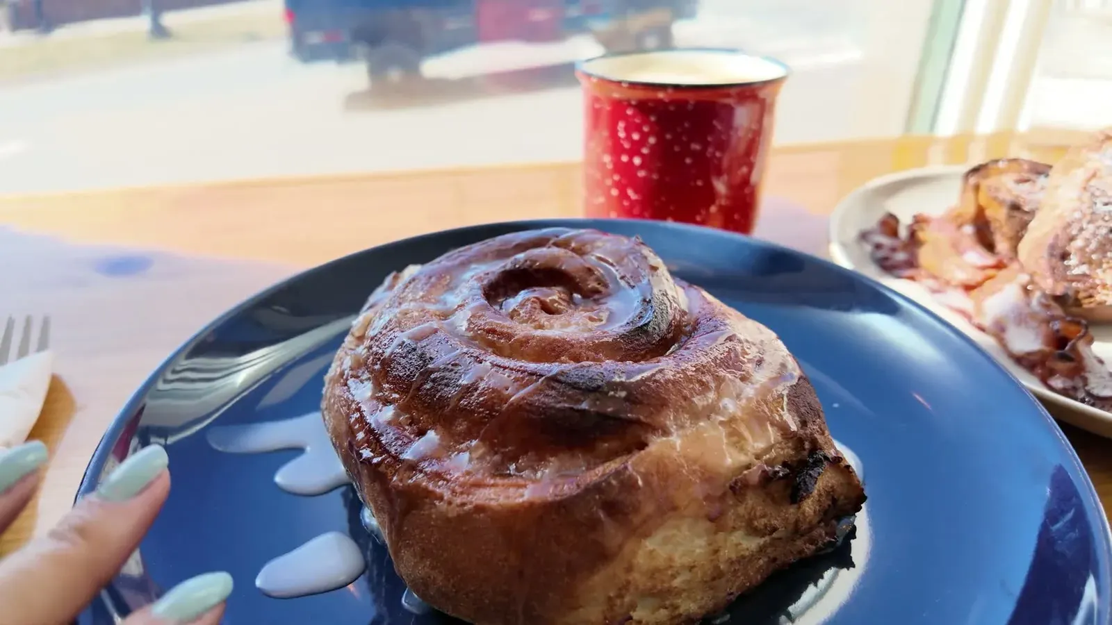 The cinnamon roll of the week, glossy and taking up most of the plate before we even picked up a fork.