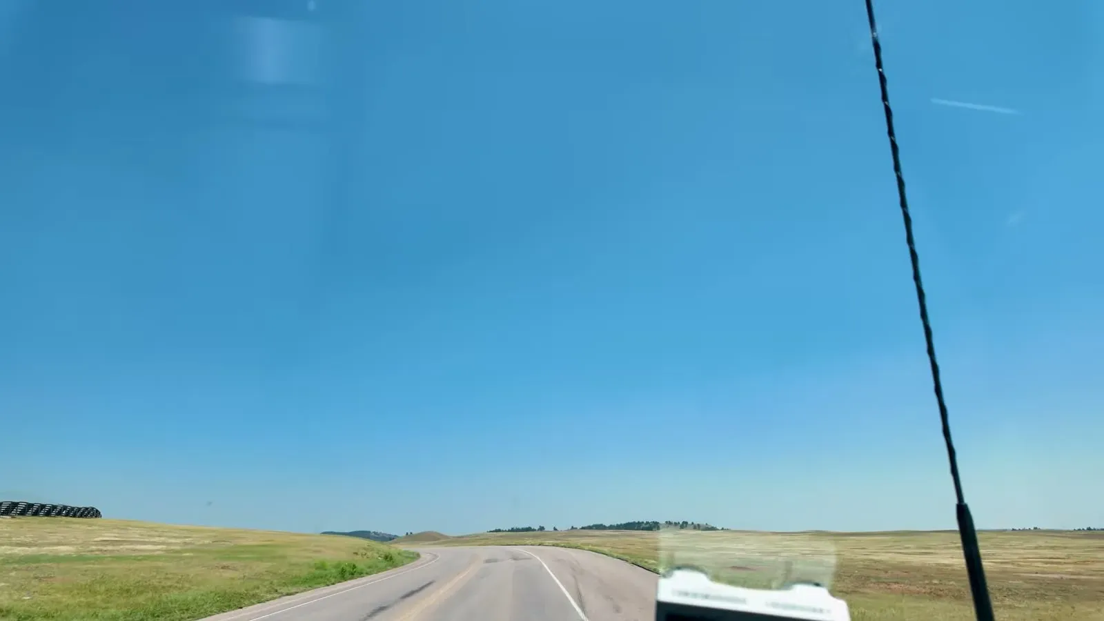 Open golden prairie stretching away on both sides of the road inside Wind Cave National Park