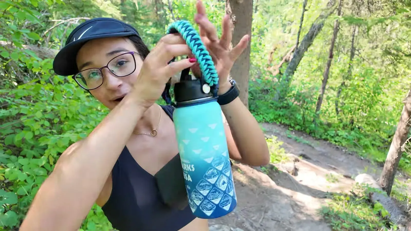 Fabiola holding up the single water bottle we brought between us for the whole hike