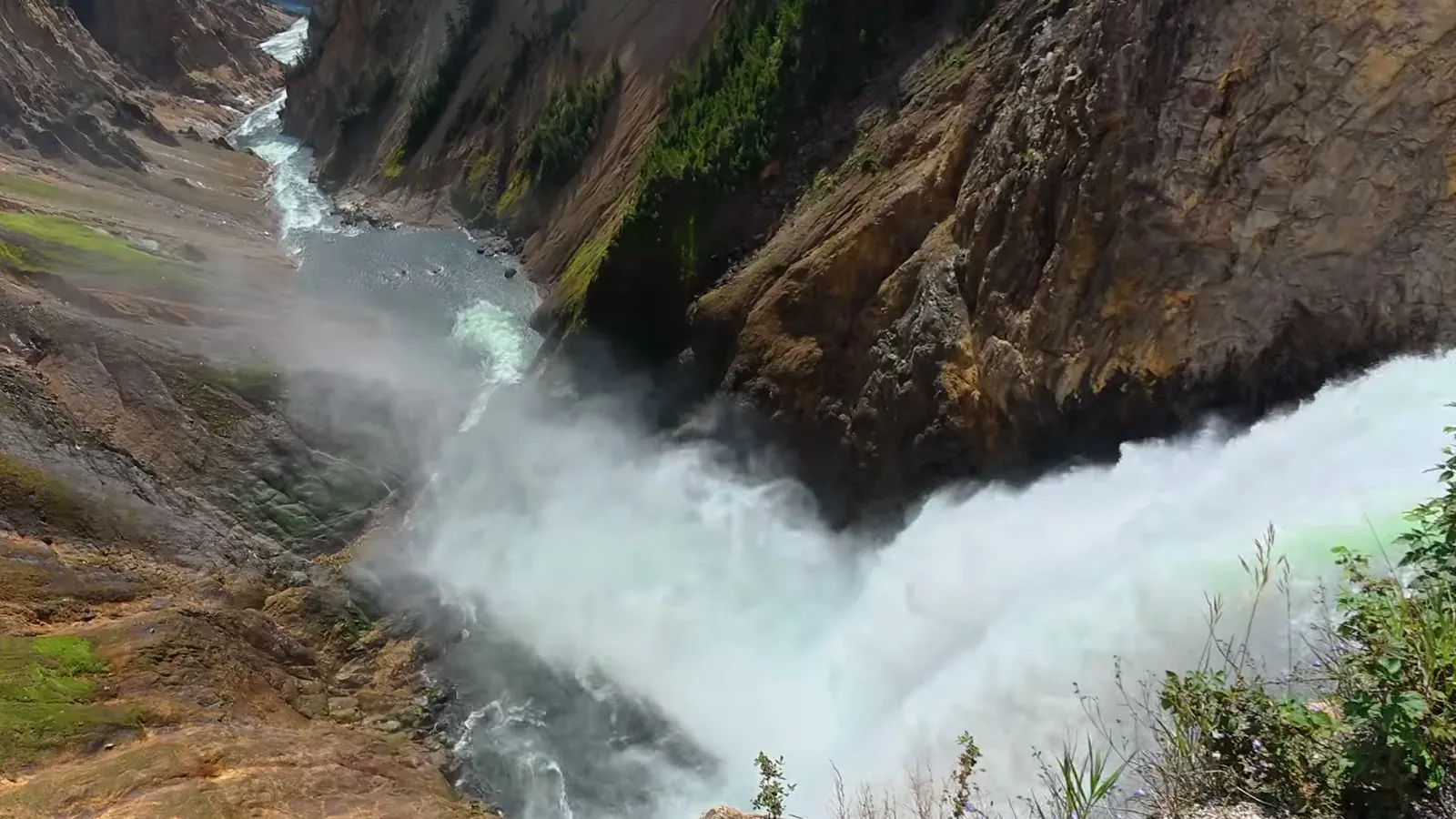 Looking straight down from the Brink of the Lower Falls as the Yellowstone River pours over into the yellow canyon