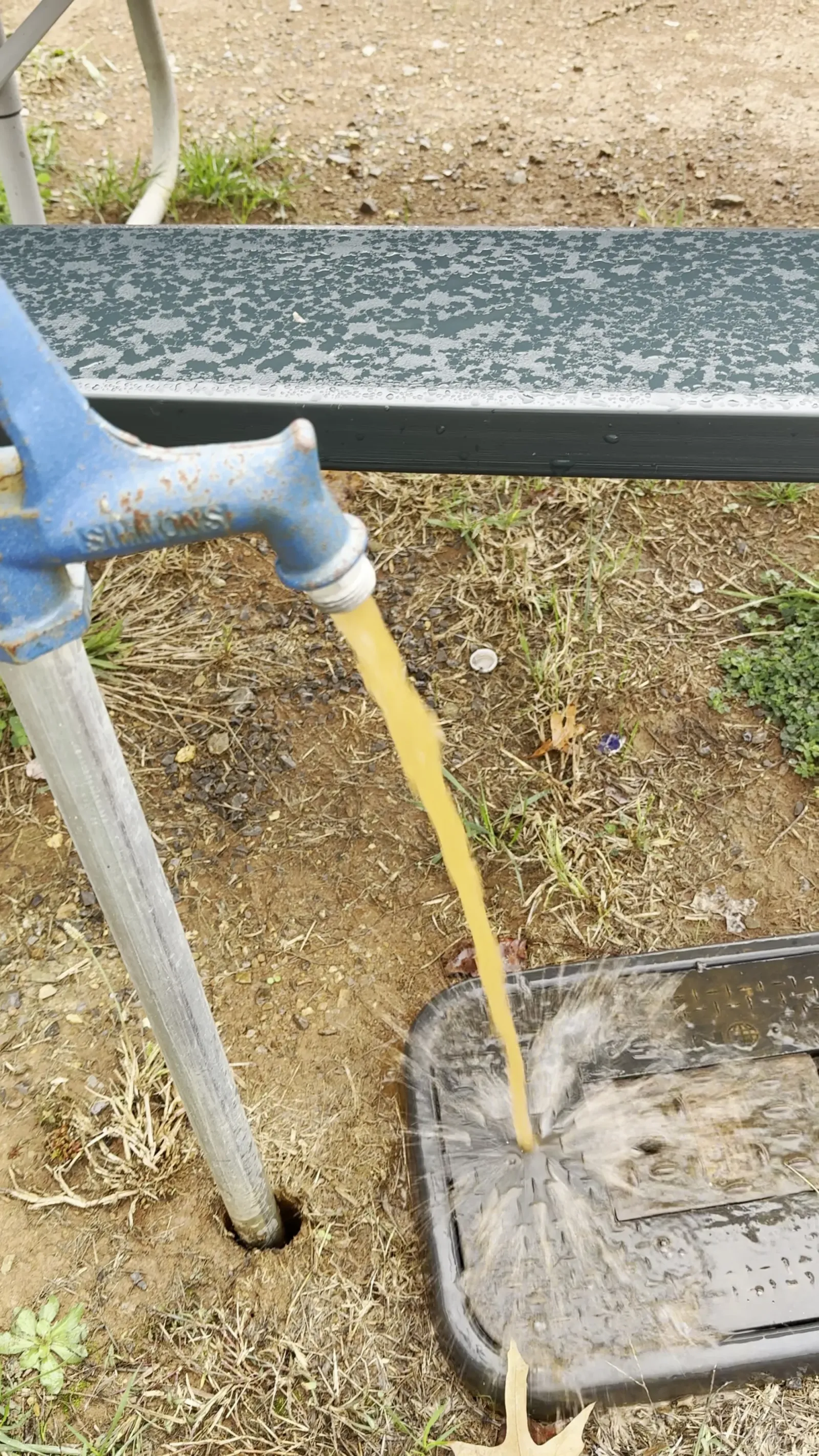Brown, rusty-looking water running out of the campsite water spigot at Appalachian Springs Outdoor Resort in Pigeon Forge