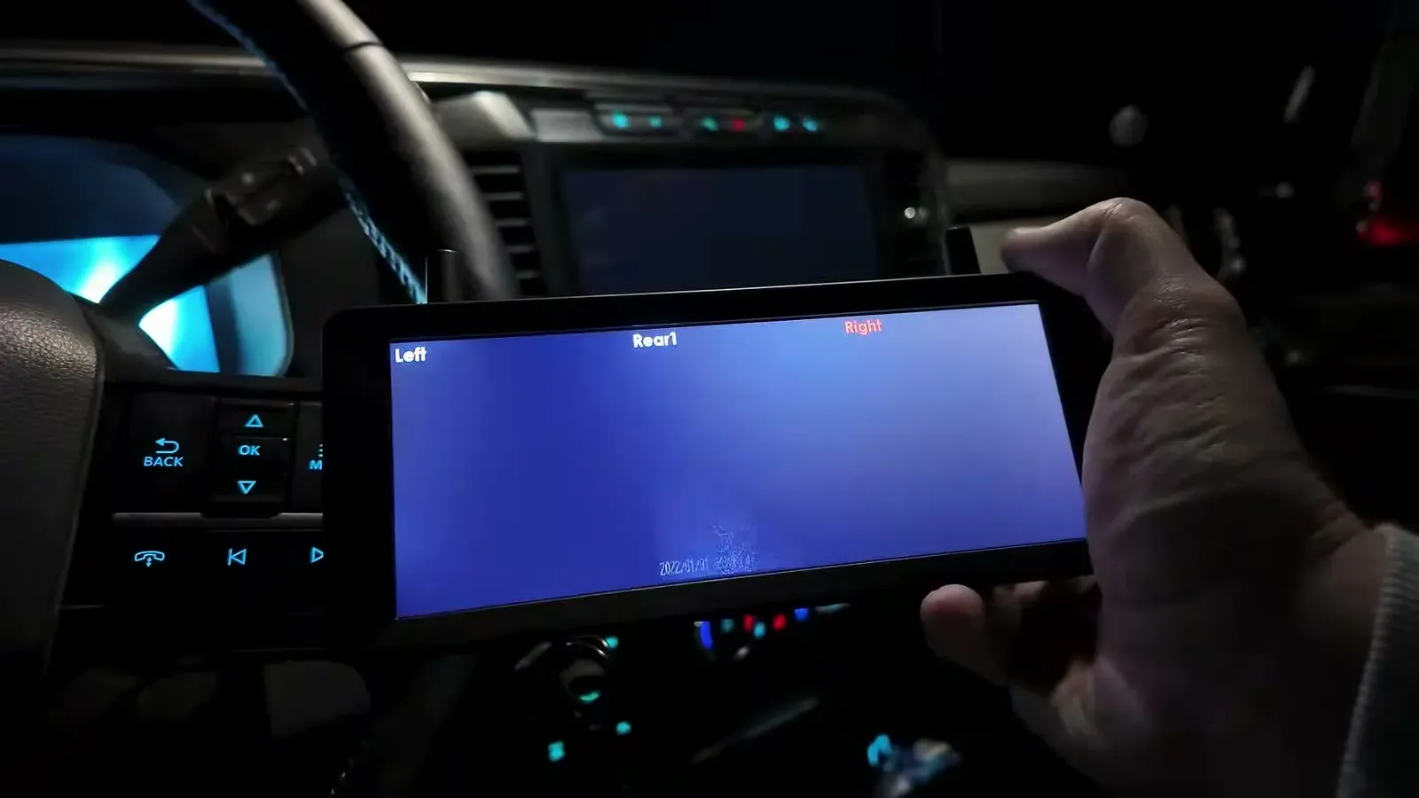 The CampSync monitor in the truck at night with Left, Rear and Right labels across the top, the Right label in red with no picture