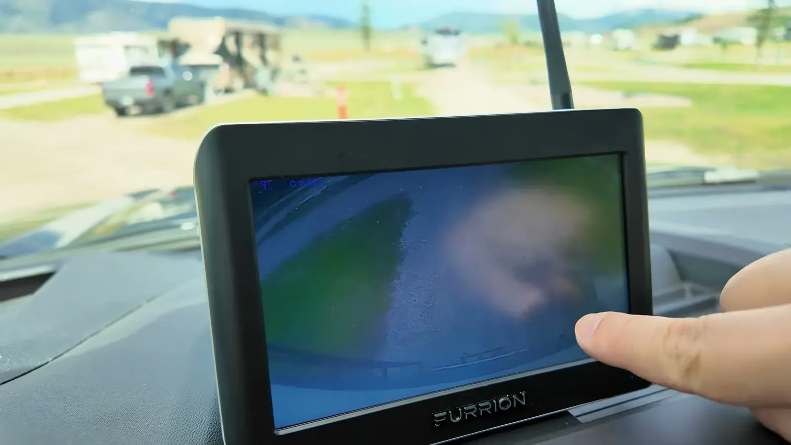 Our old Furrion monitor on the truck dash showing a blurry, washed-out picture from the factory backup camera