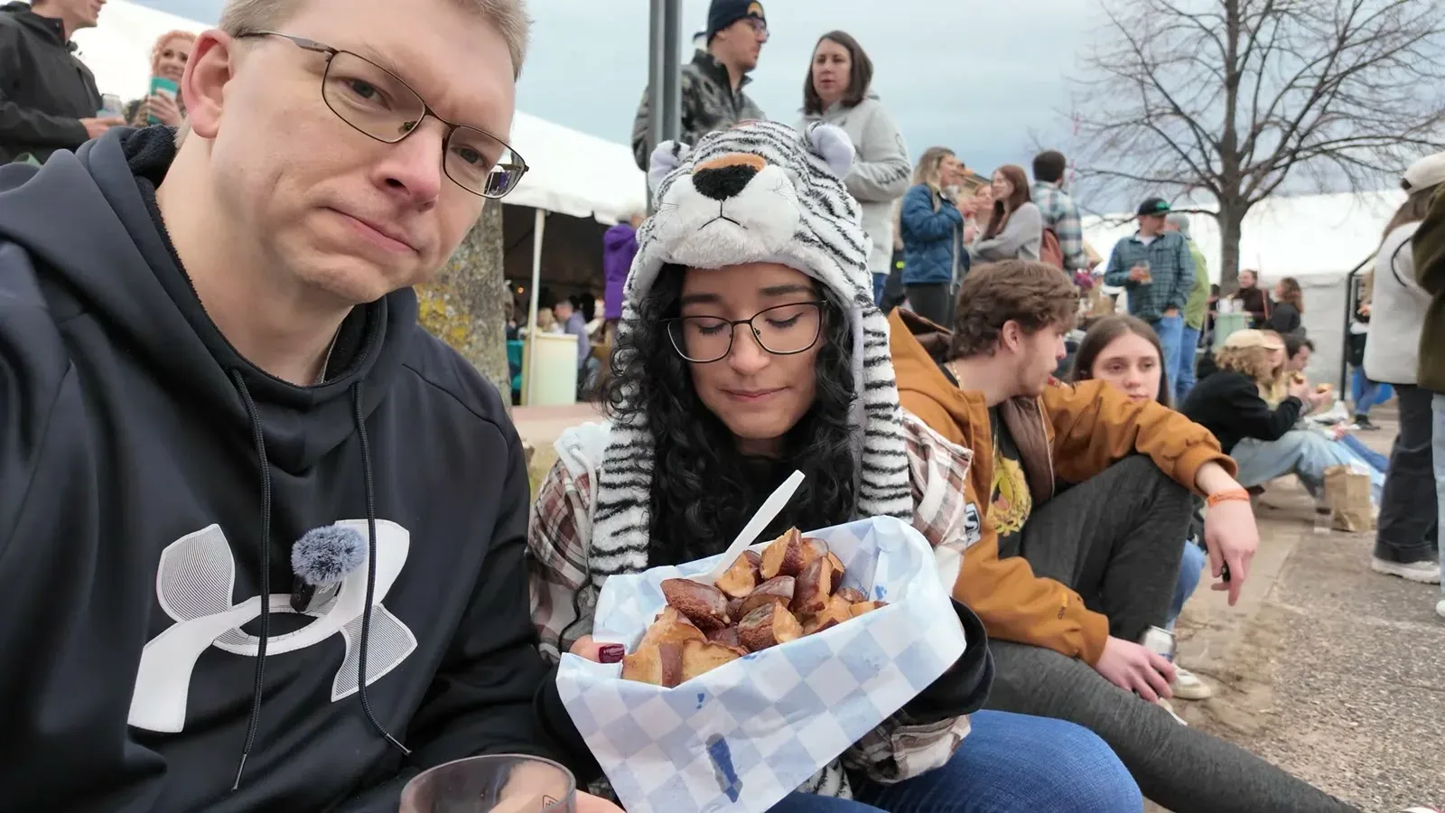 Digging into a basket of DaH Pretzel Guys pretzel bites while sitting in the festival crowd.