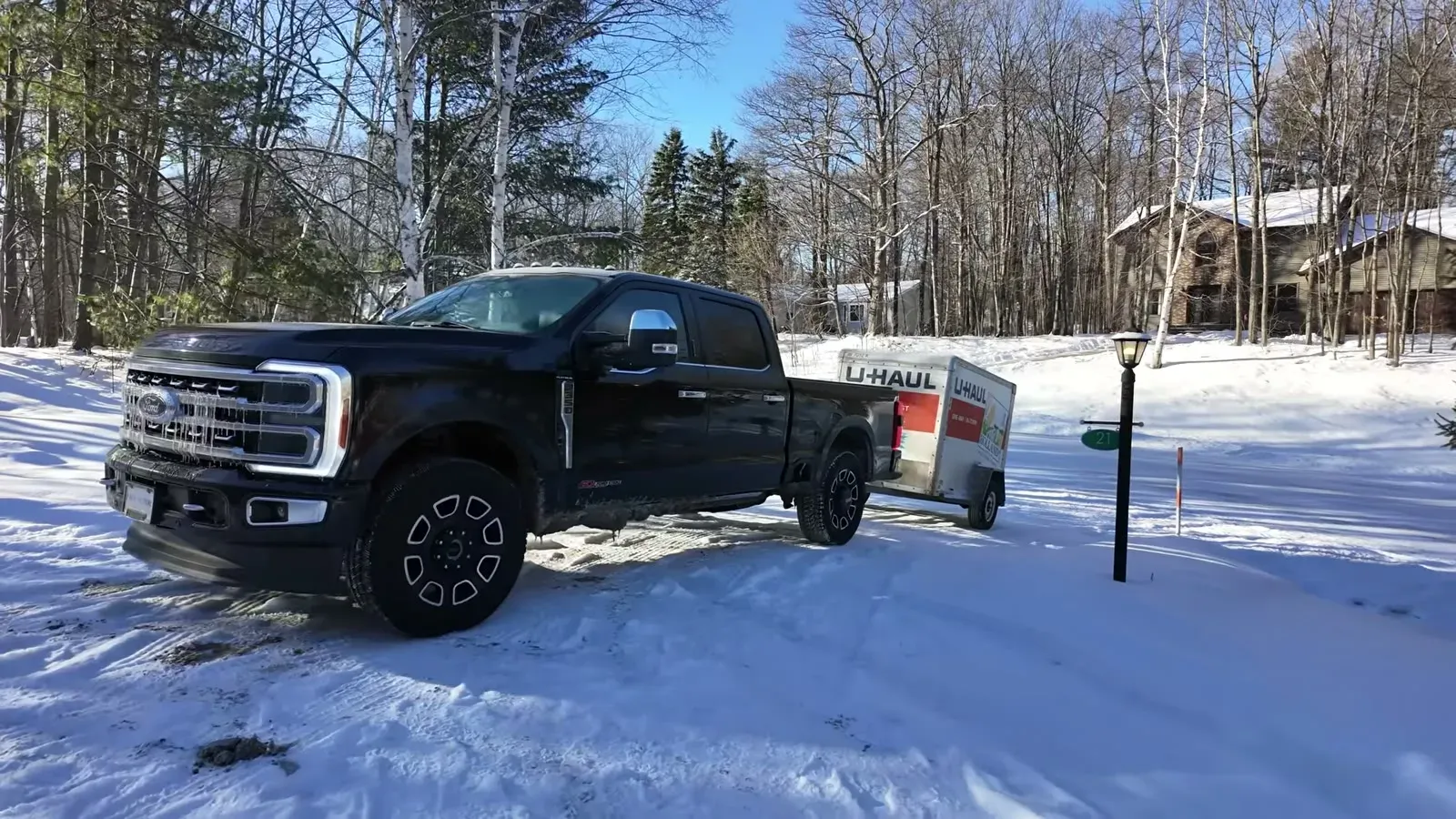 Our Ford Super Duty hitched to a U-Haul trailer in the snowy Michigan driveway the day we set out.