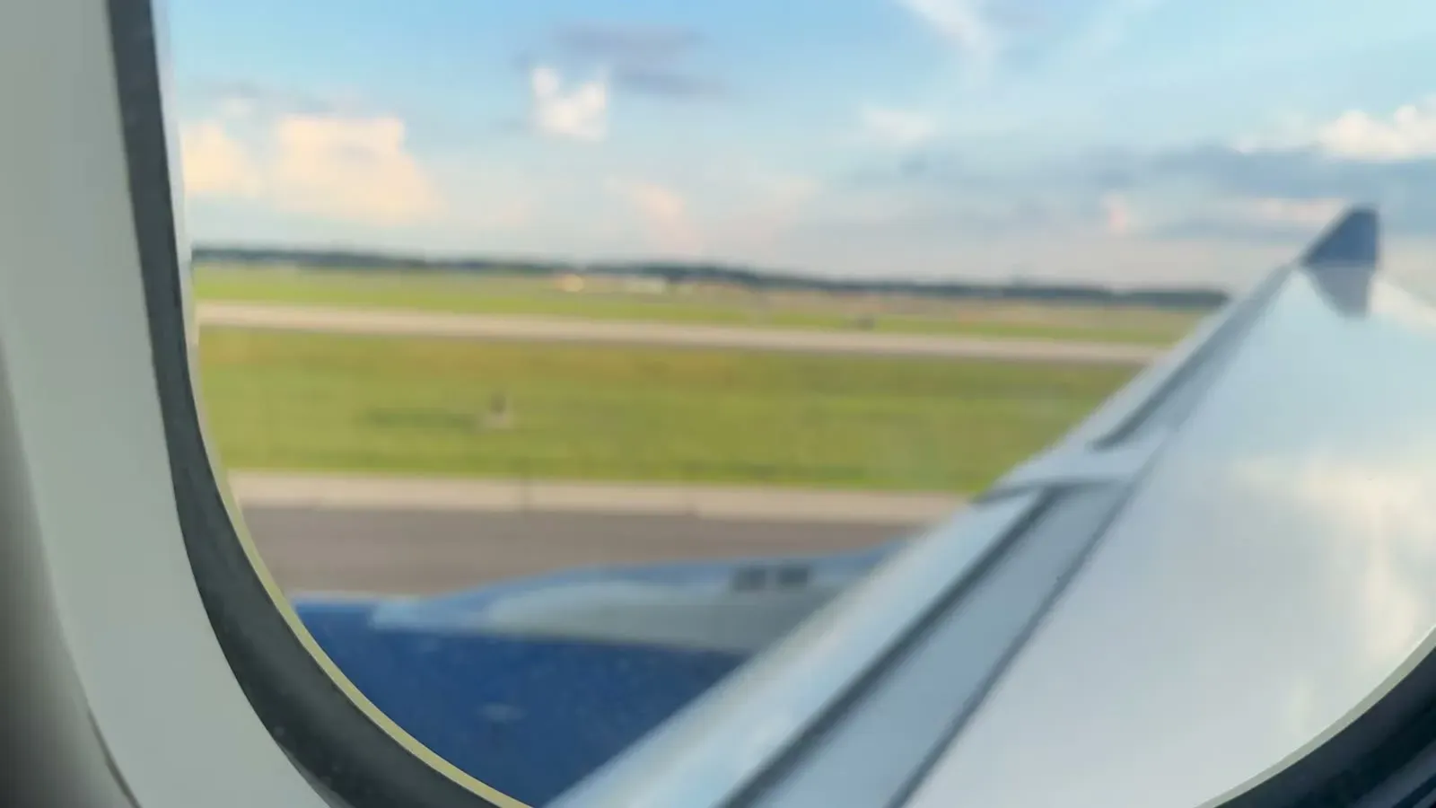 The view over the wing as our flight out of Chicago rolls down the runway, Brazil-bound at last.