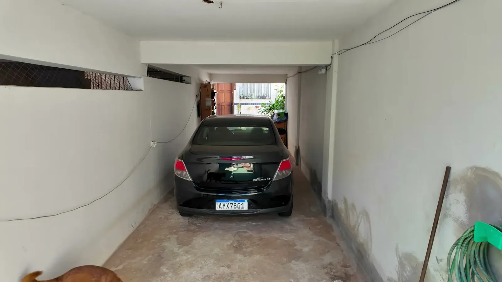 The garage at our Brazil home, with the car parked inside and the big street gate that every house here has.