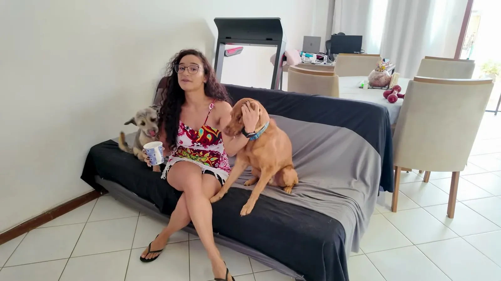 Fabiola on the couch with Bolt and Belinha, our two rescue pups soaking up the reunion.