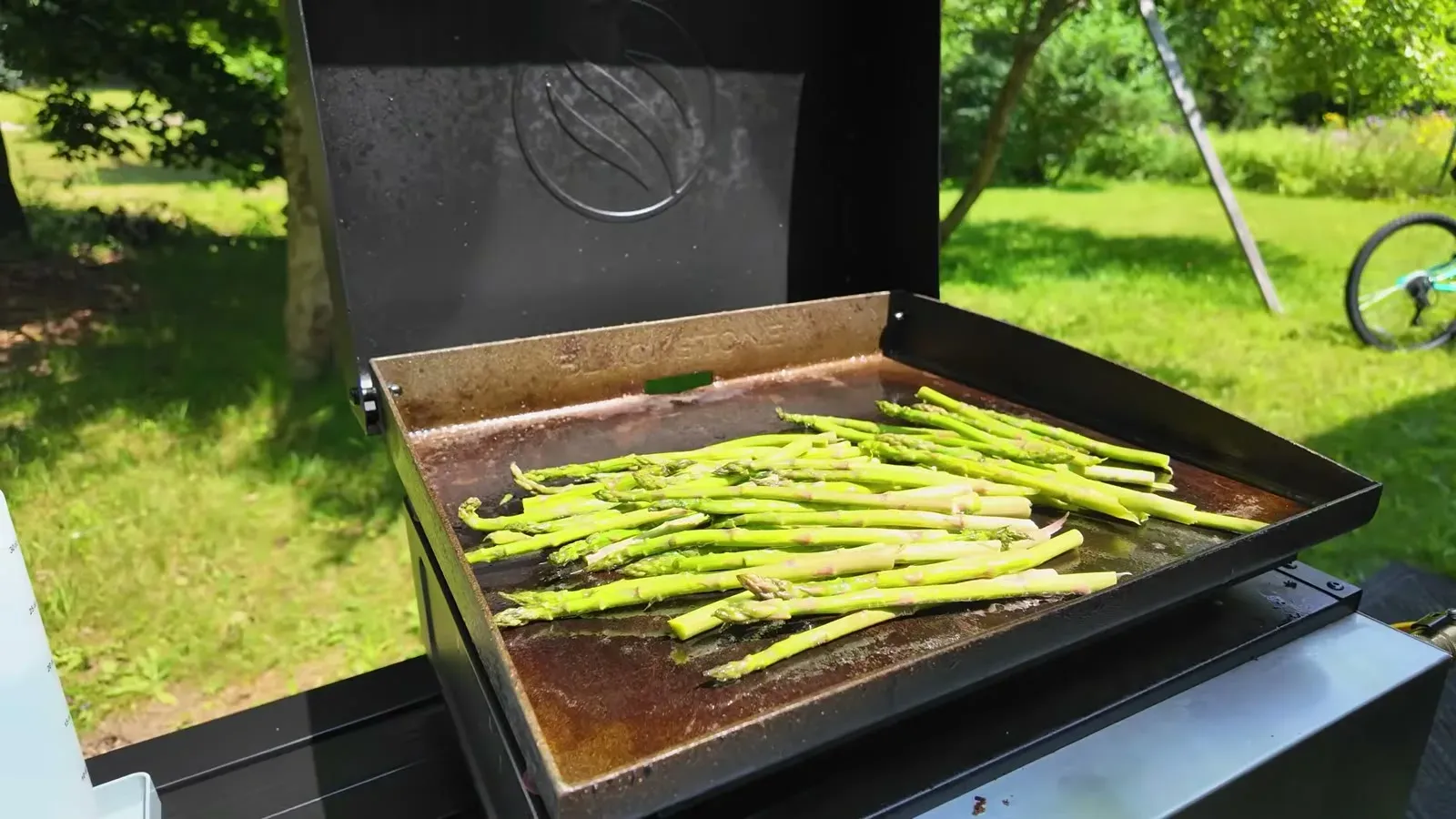 Asparagus sizzling on the Blackstone griddle set up outside the rig in Marquette.