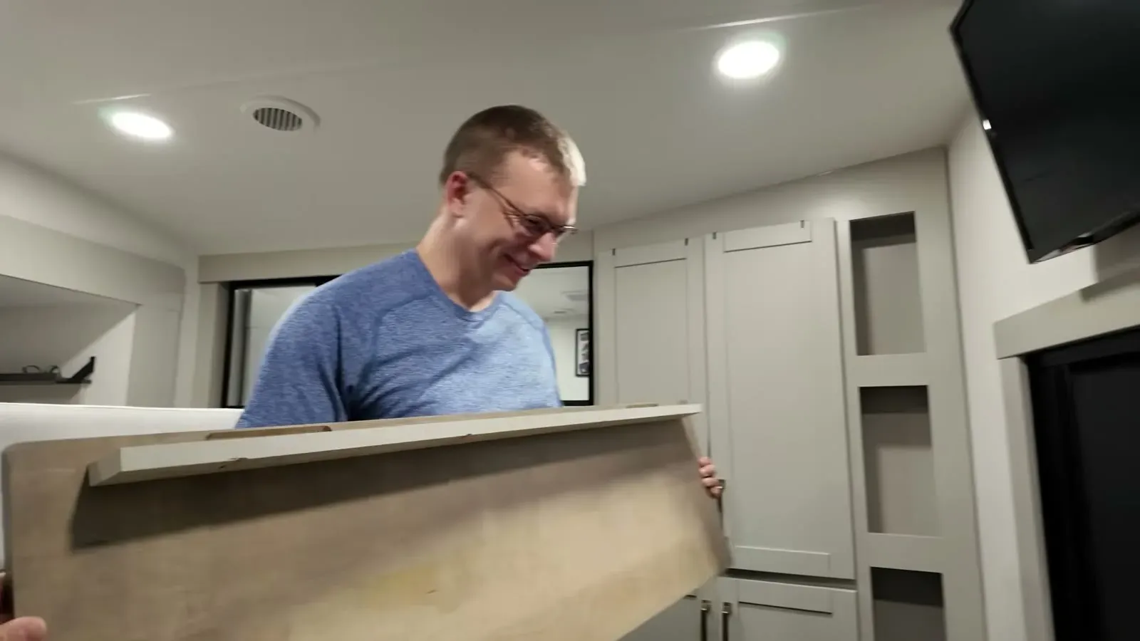 Nathan carries the new dresser insert through the bedroom, third attempt at this part in hand.
