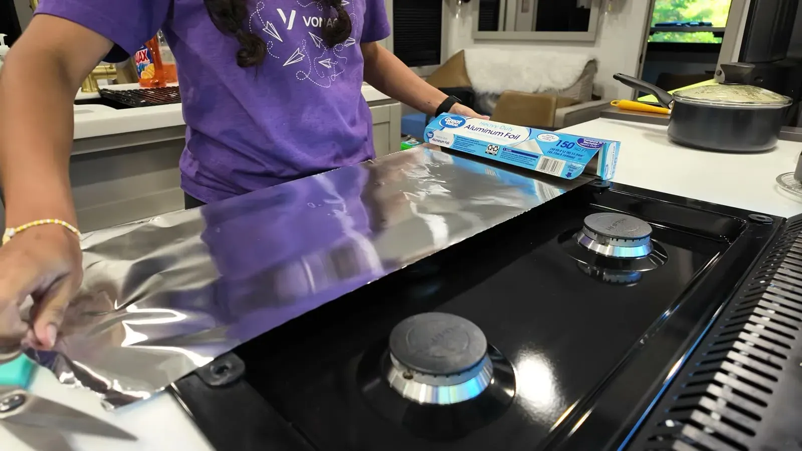 Lining the RV stove top with aluminum foil so cooking mess wipes away instead of baking on.