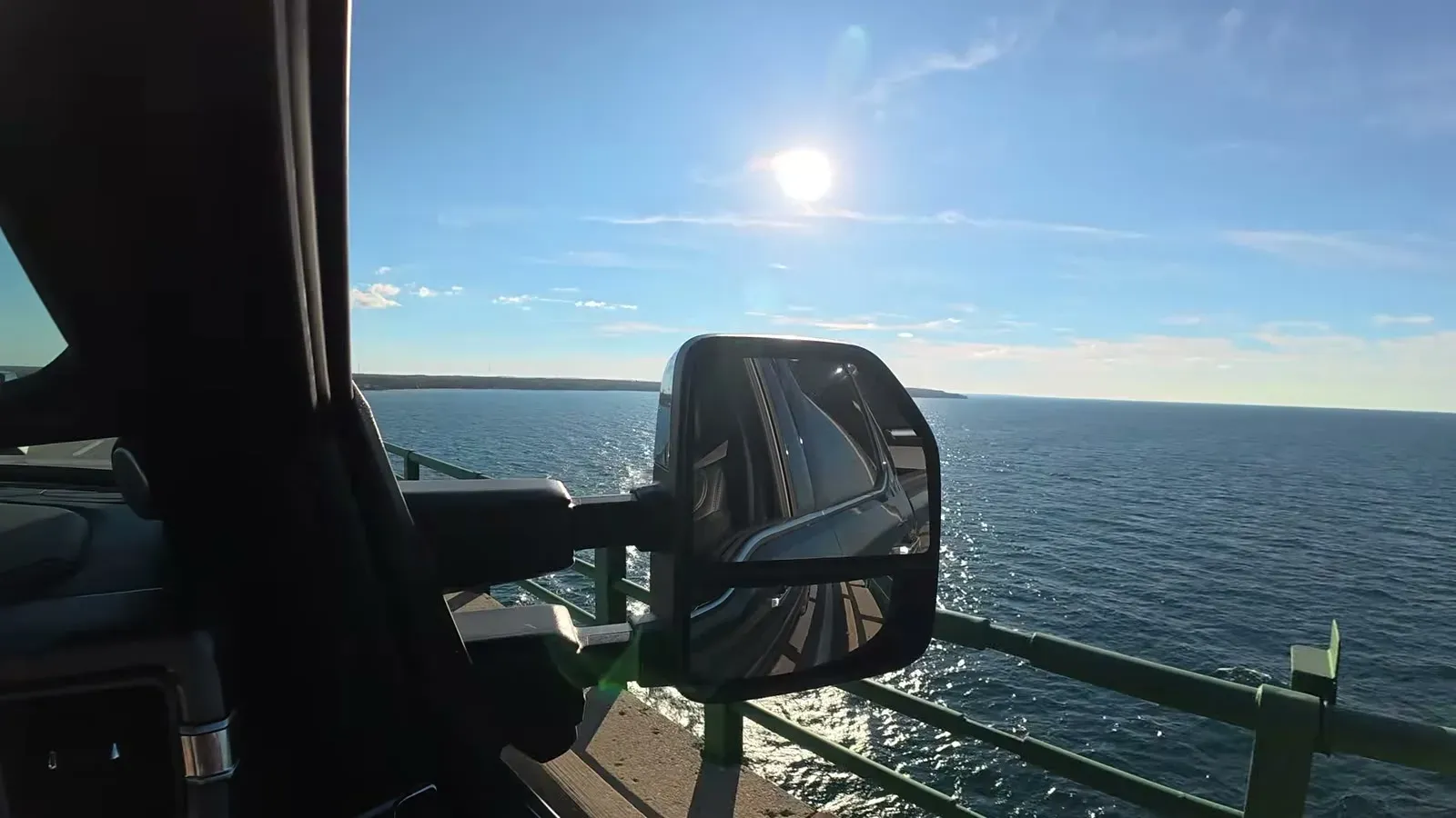 The Straits of Mackinac shining in the tow mirror as we cross the Mackinac Bridge.