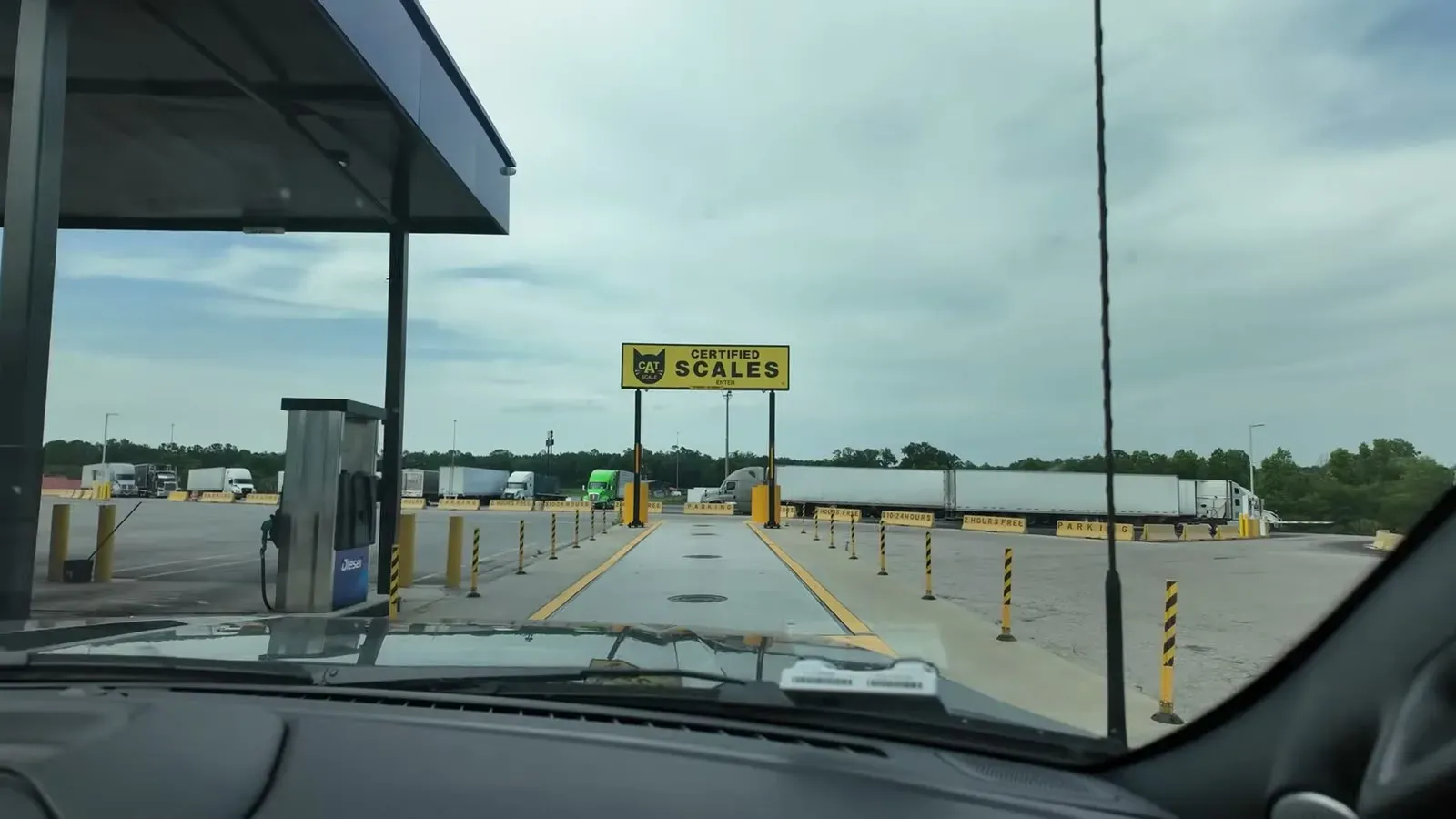 The certified CAT scale lane framed in the windshield as we line the truck and trailer up for the first weigh.