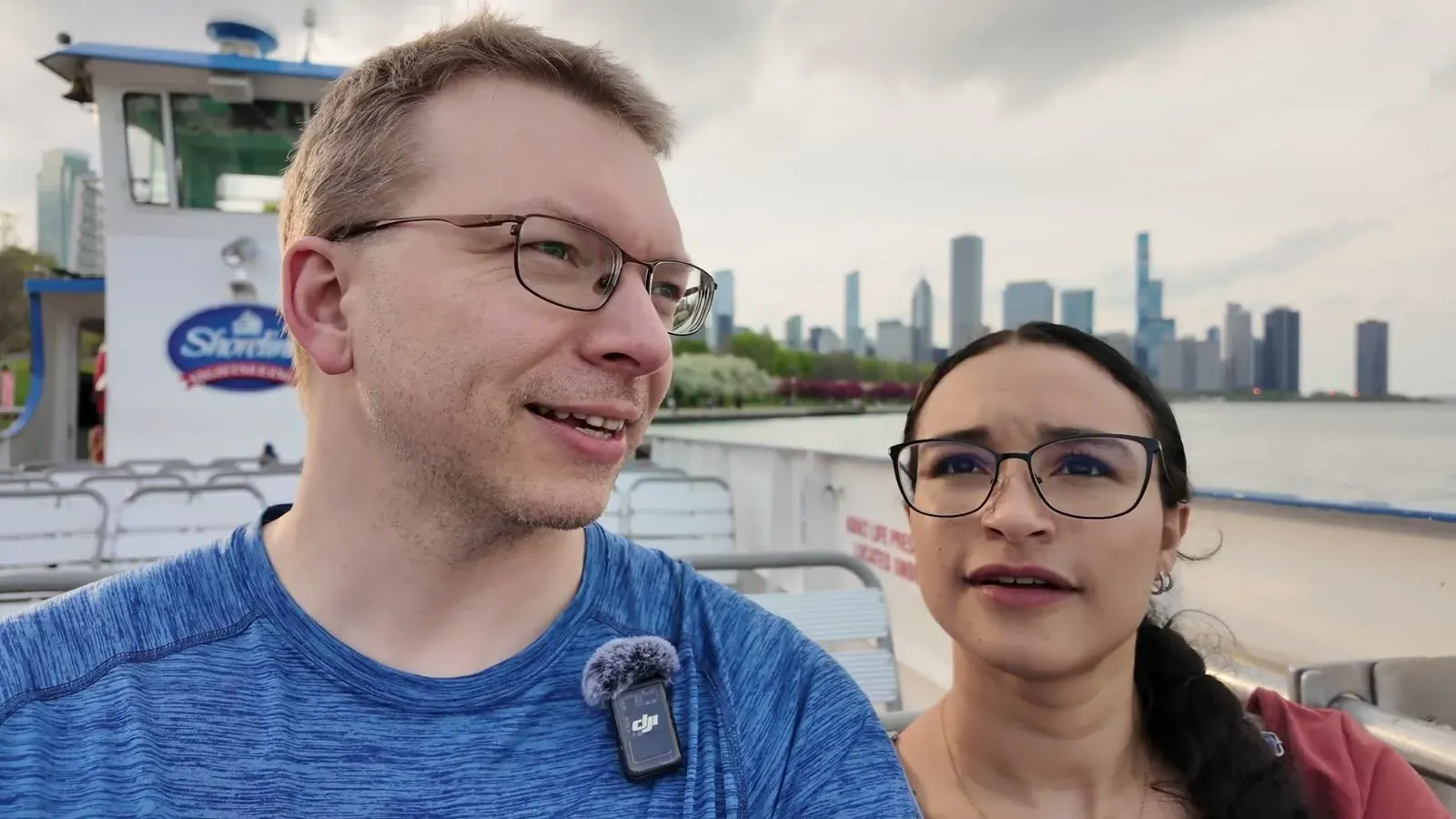 Nathan and Fabiola on the deck of the Shoreline water taxi with the Chicago skyline rising across the lake behind them.