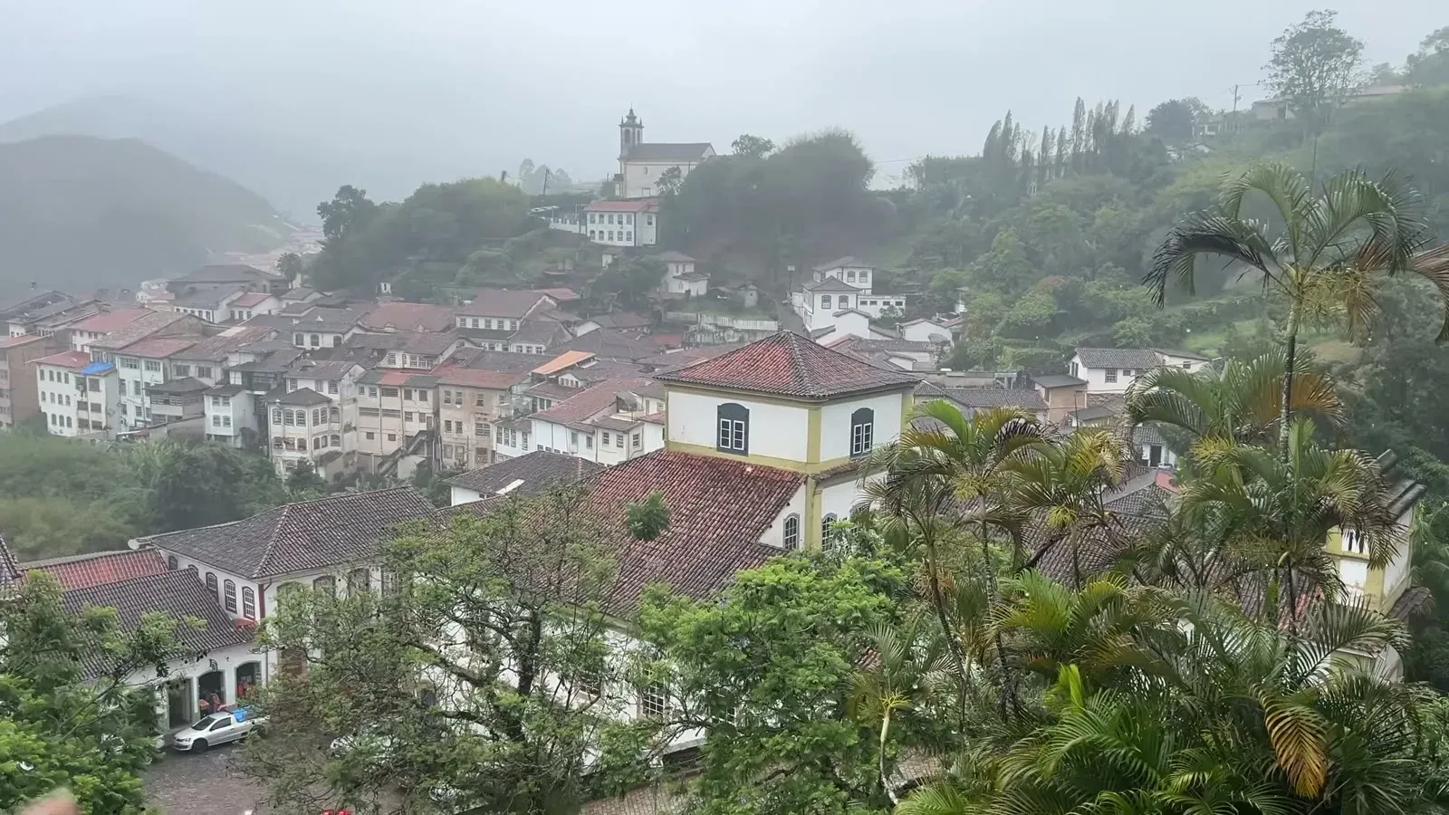 Red rooftops and a hillside church poking through the fog, the view we stared at from our hotel window all day.