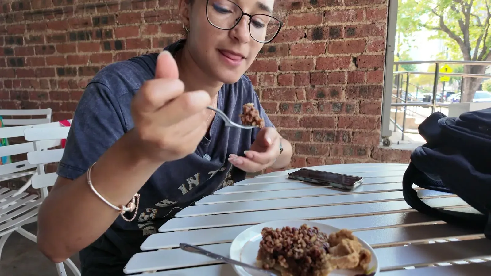 Fabiola digging into a slice on the patio at Emporium Pies in Deep Ellum.