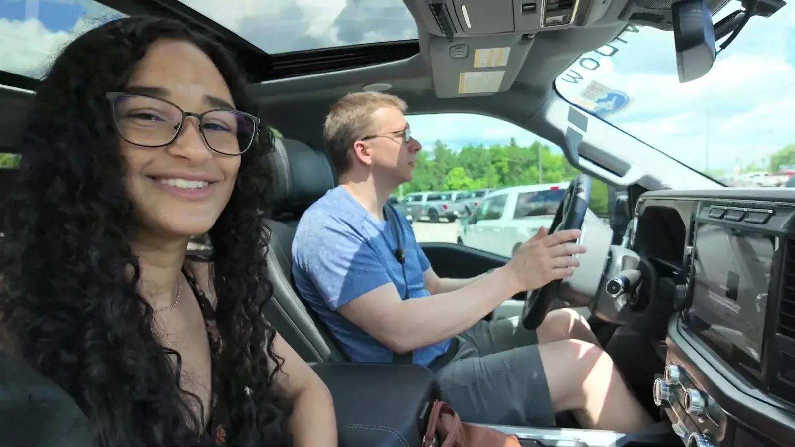 Fabiola grinning from the passenger seat while Nathan takes the F-350 out for his first drive in a one-ton.