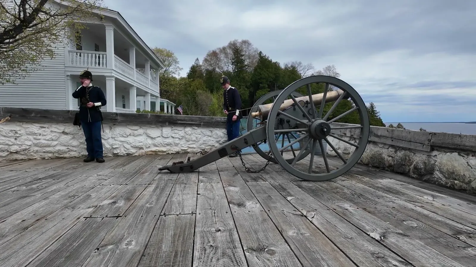 Costumed interpreters ready the cannon on Fort Mackinac's wooden gun platform before the salute shot.