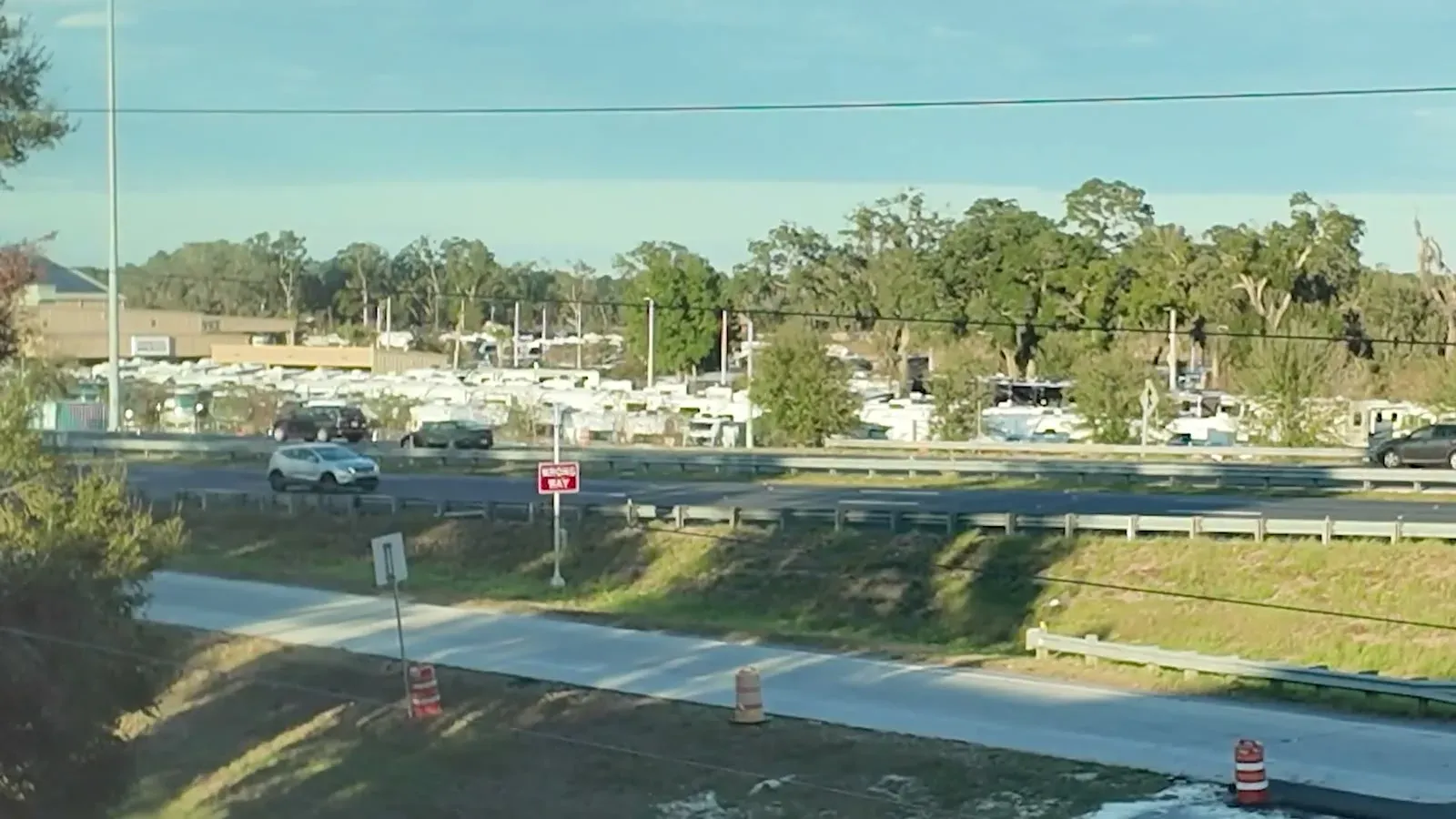 Warm sun, green grass, and rows of RVs across the road after four days of winter driving.