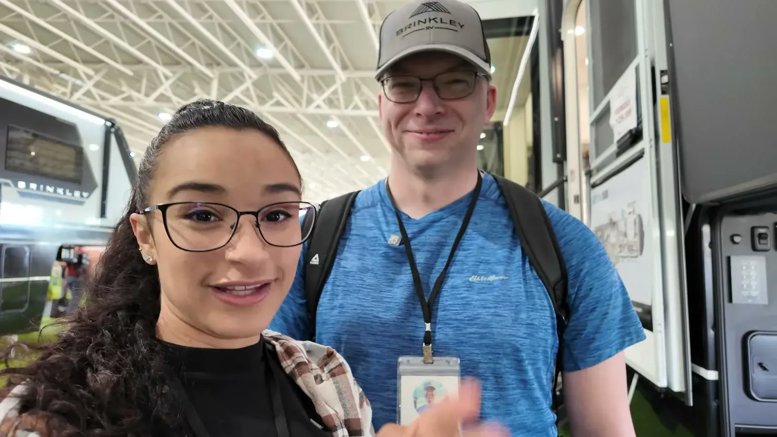 Nathan and Fabiola stepping up to the new Brinkley GX 3500 at the Tampa RV Super Show, entry door open behind them.