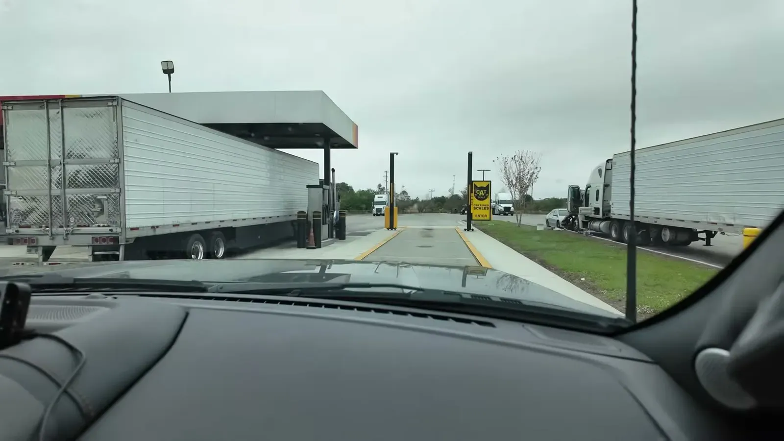 Rolling up to the CAT scale platform between two semis at the truck stop.