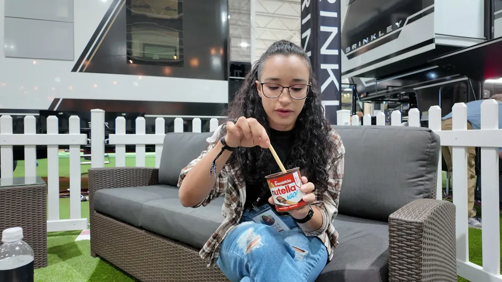 Fabiola on a couch in the Brinkley owners lounge, dipping a breadstick into a Nutella and Go cup for the first time.
