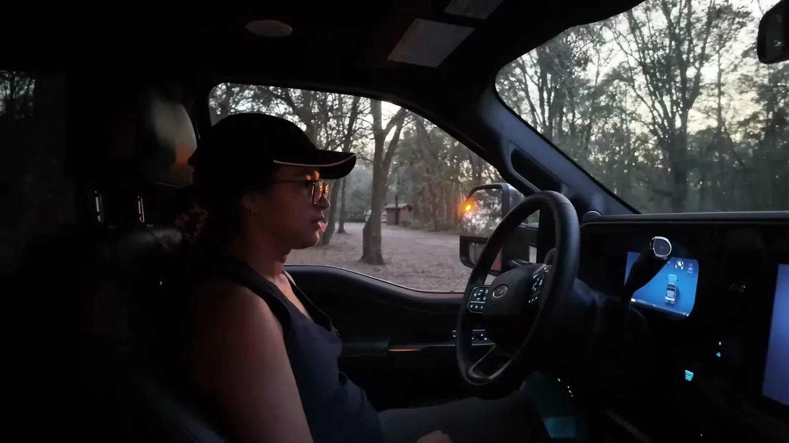 Fabiola settling into the driver's seat of the F-350 at dusk before her first drive.