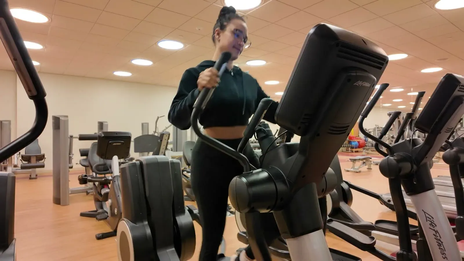 Fabiola on an elliptical machine in the hotel fitness center, our brief attempt at balancing out several days of conference food.