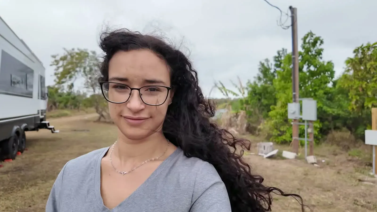 Fabiola stands in front of the fifth wheel with her hair whipping sideways in the gusts before we pulled out.