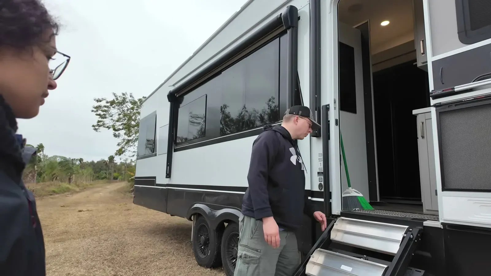 Nathan at the fifth wheel door retracting the entry steps we forgot were down, again.