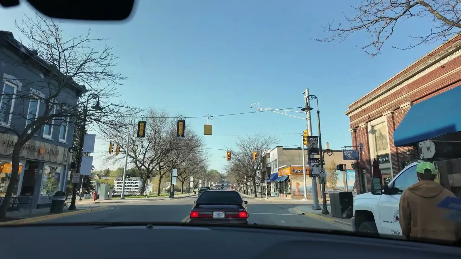 The view through the windshield rolling down a small-town main street on the drive south toward Traverse City.