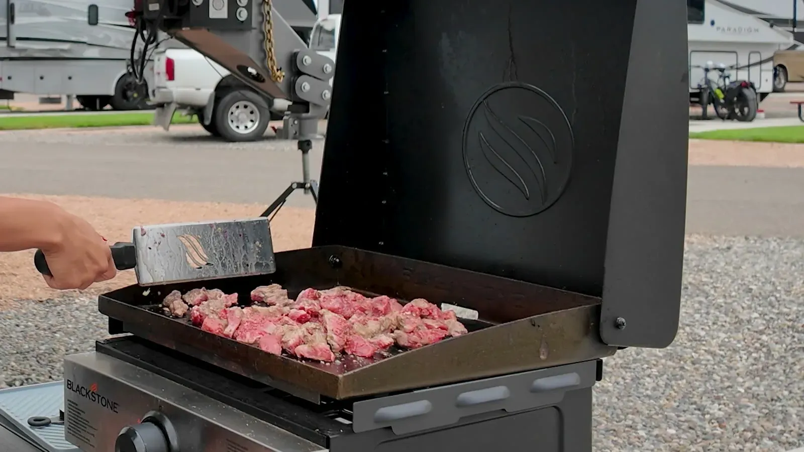 Pieces of steak searing on our Blackstone griddle outside the RV