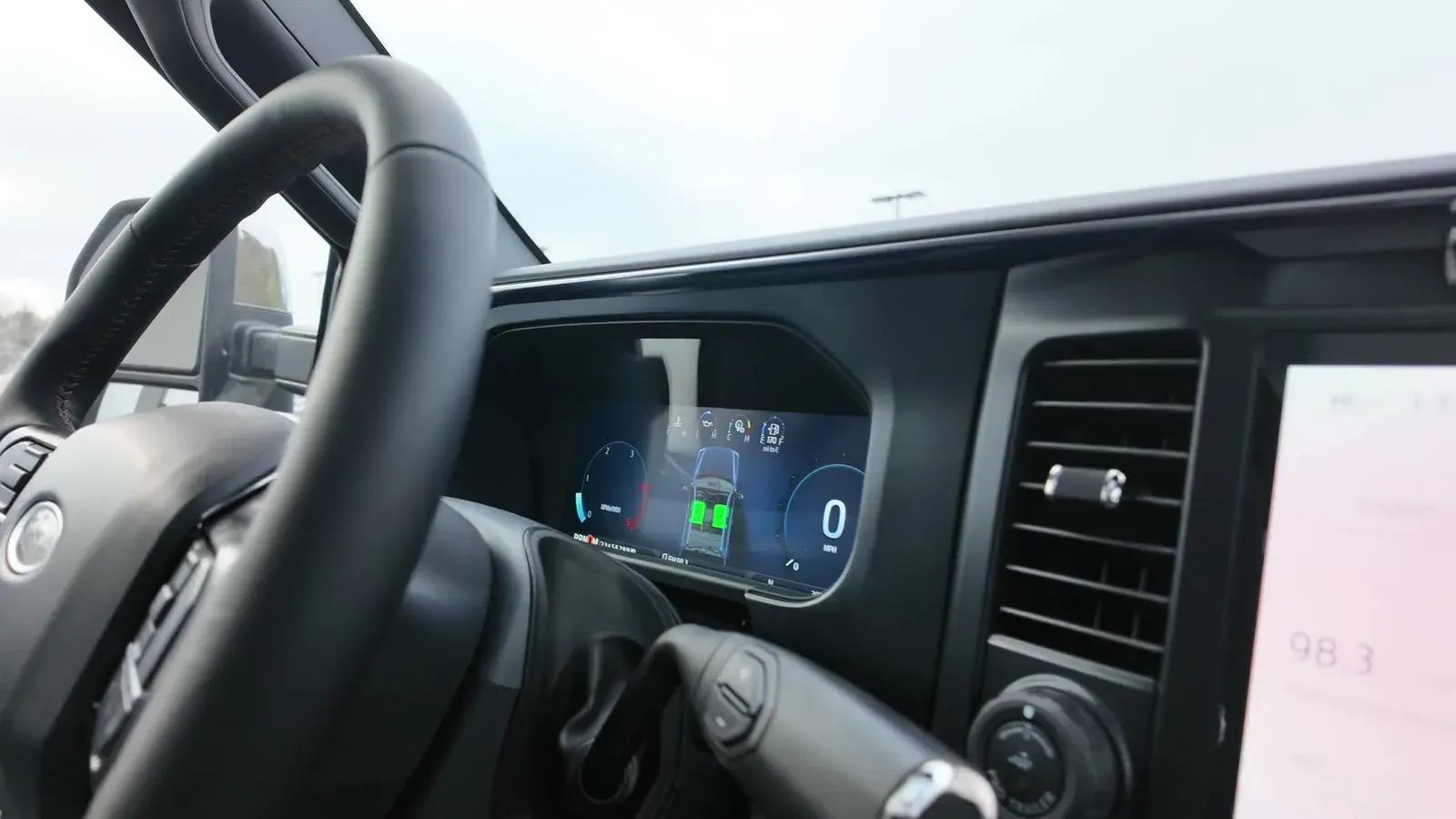 The Platinum's digital gauge cluster and wide center touchscreen seen from the driver's seat.