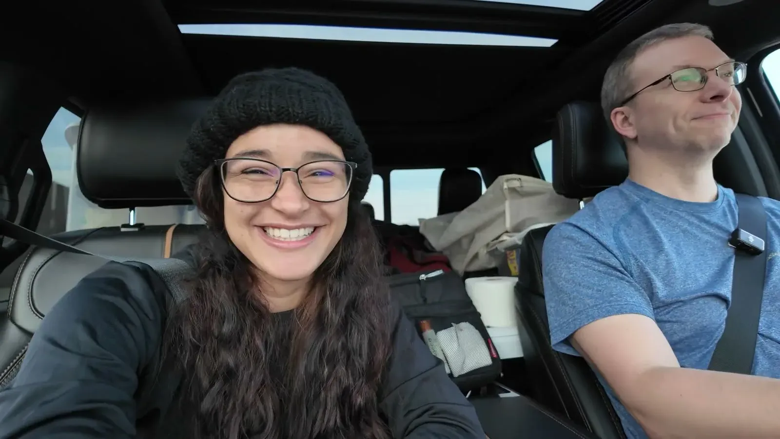 The two of us grinning in the front seats on an early drive, with the back seat already holding gear.