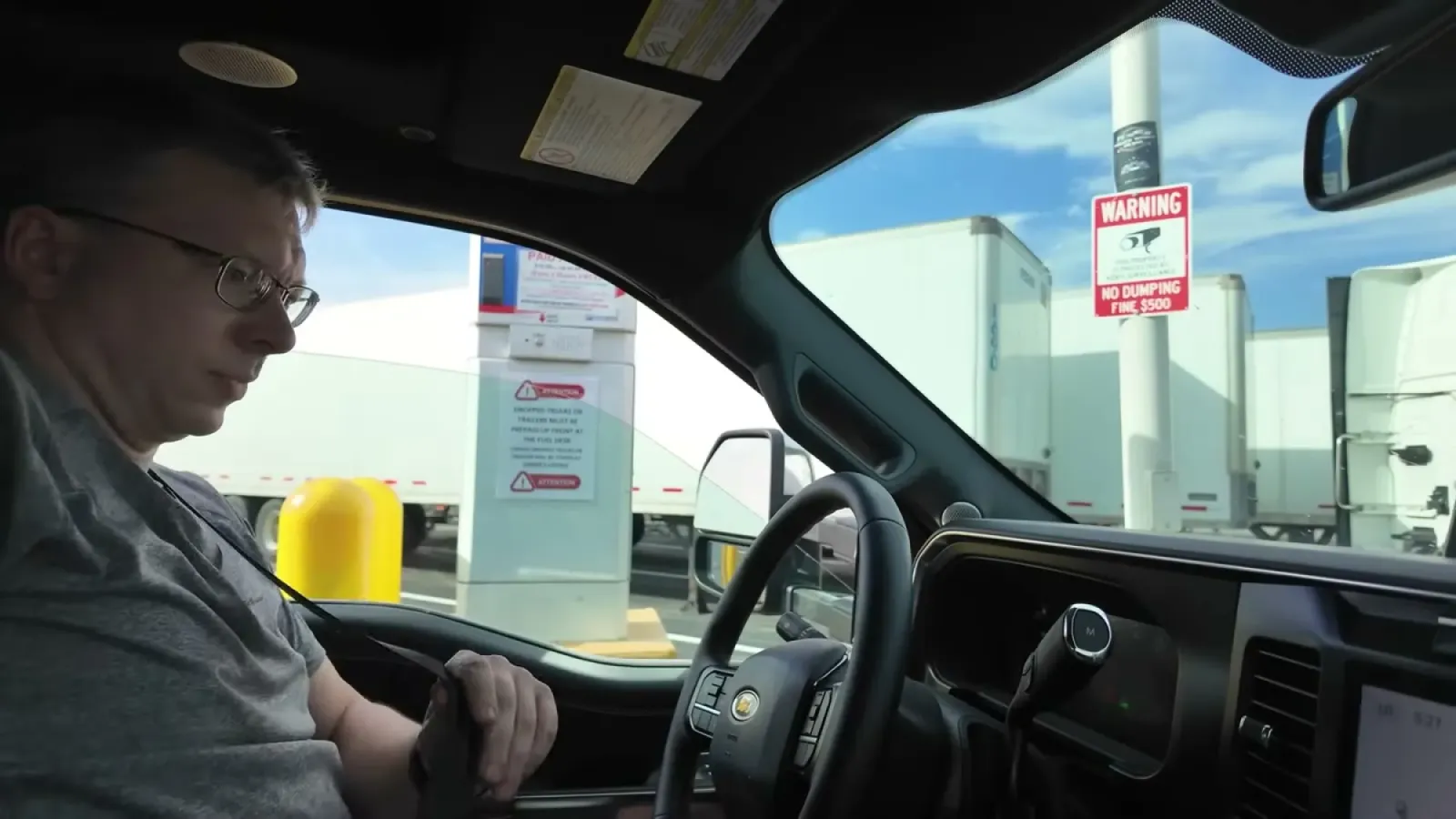 Nathan in the truck cab stopped beside the CAT scale intercom pillar while weighing the truck without the trailer