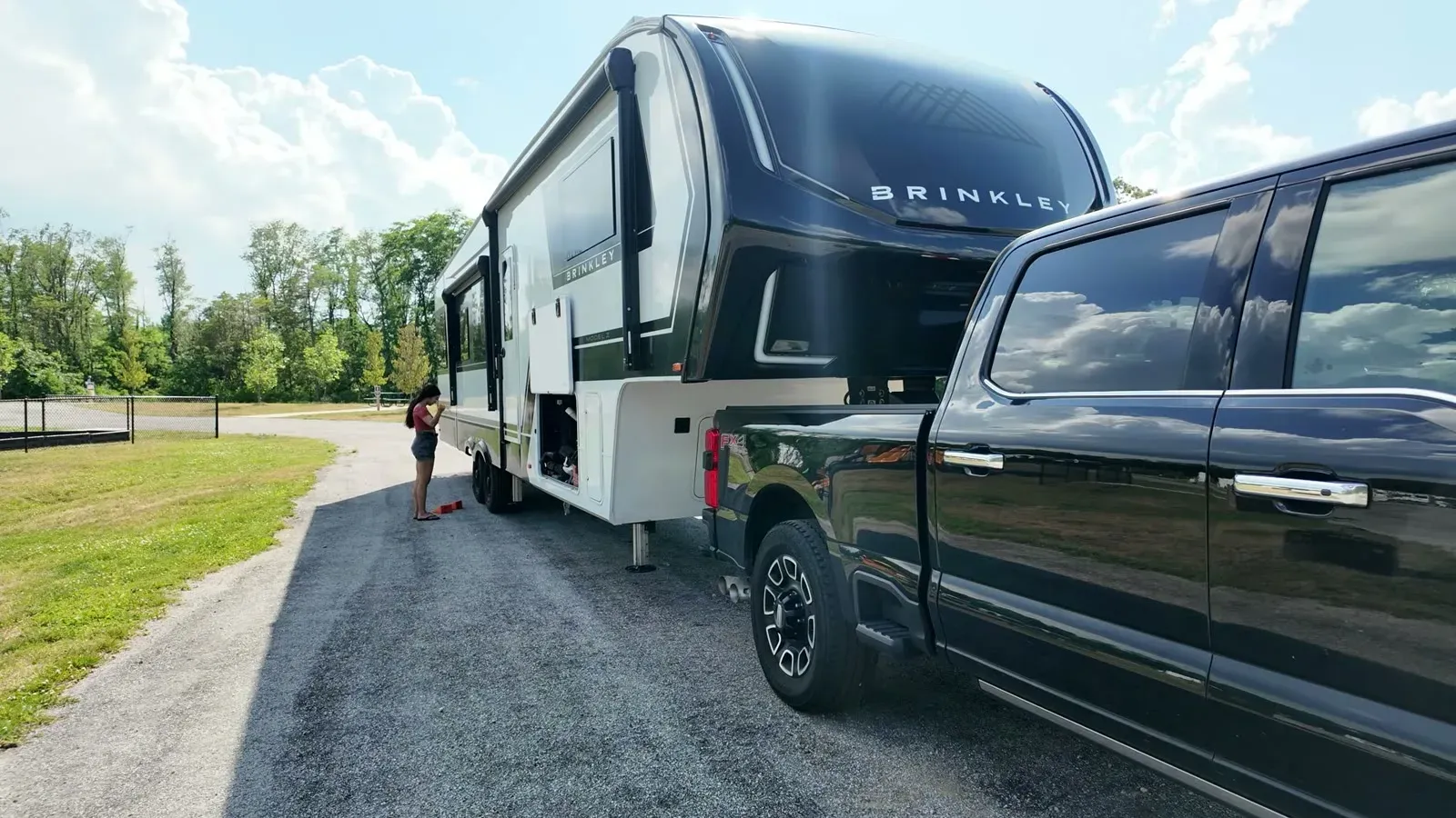 Leveling blocks staged at the fifth wheel tires while the rig stays hitched to the truck