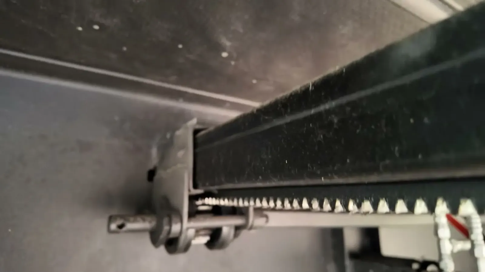 Close-up of a fifth wheel slide-out rack-and-gear mechanism where gaps can let mice into the underbelly