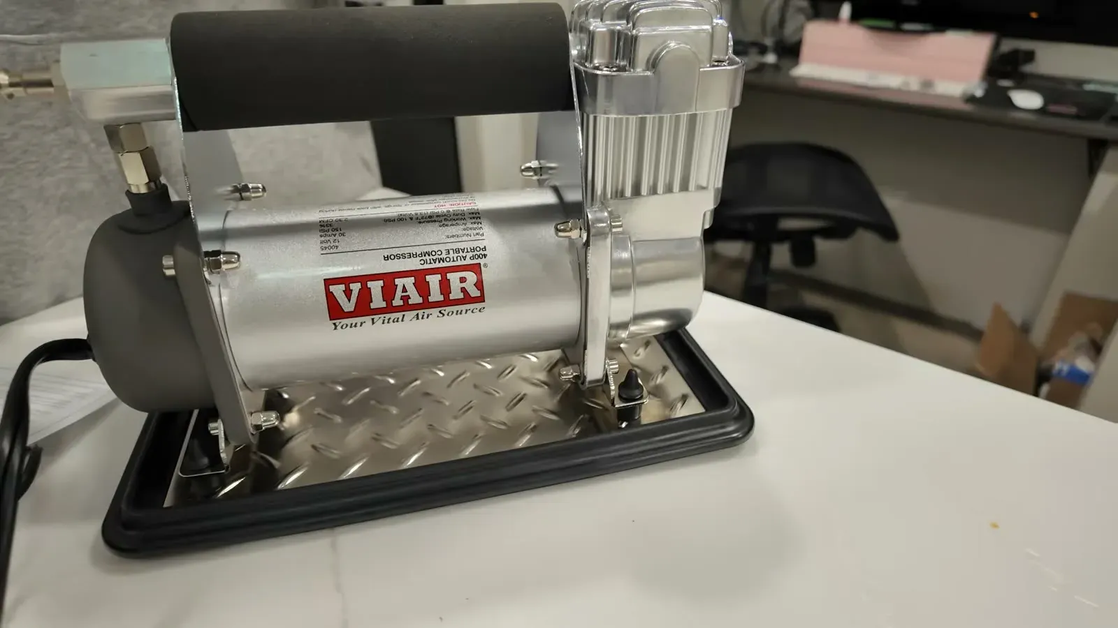 VIAIR 400P Automatic Portable Compressor sitting on its diamond-plate base plate, with the VIAIR logo and product label visible