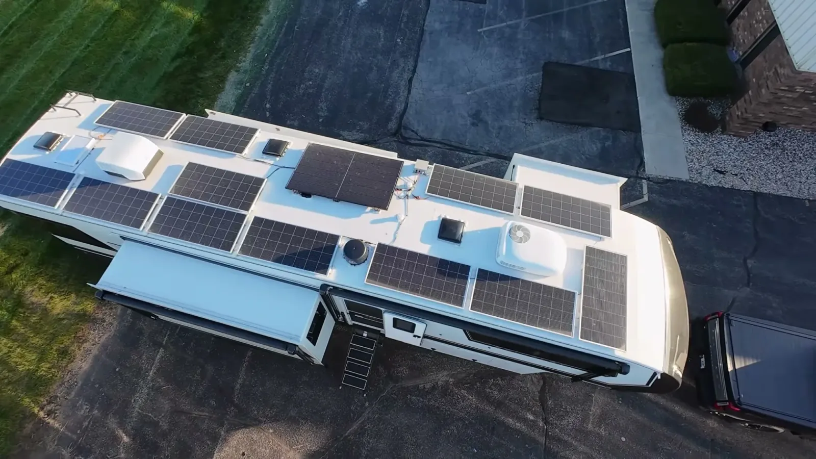 Our Starlink flat-mounted on the Brinkley roof among the solar panels, drone view