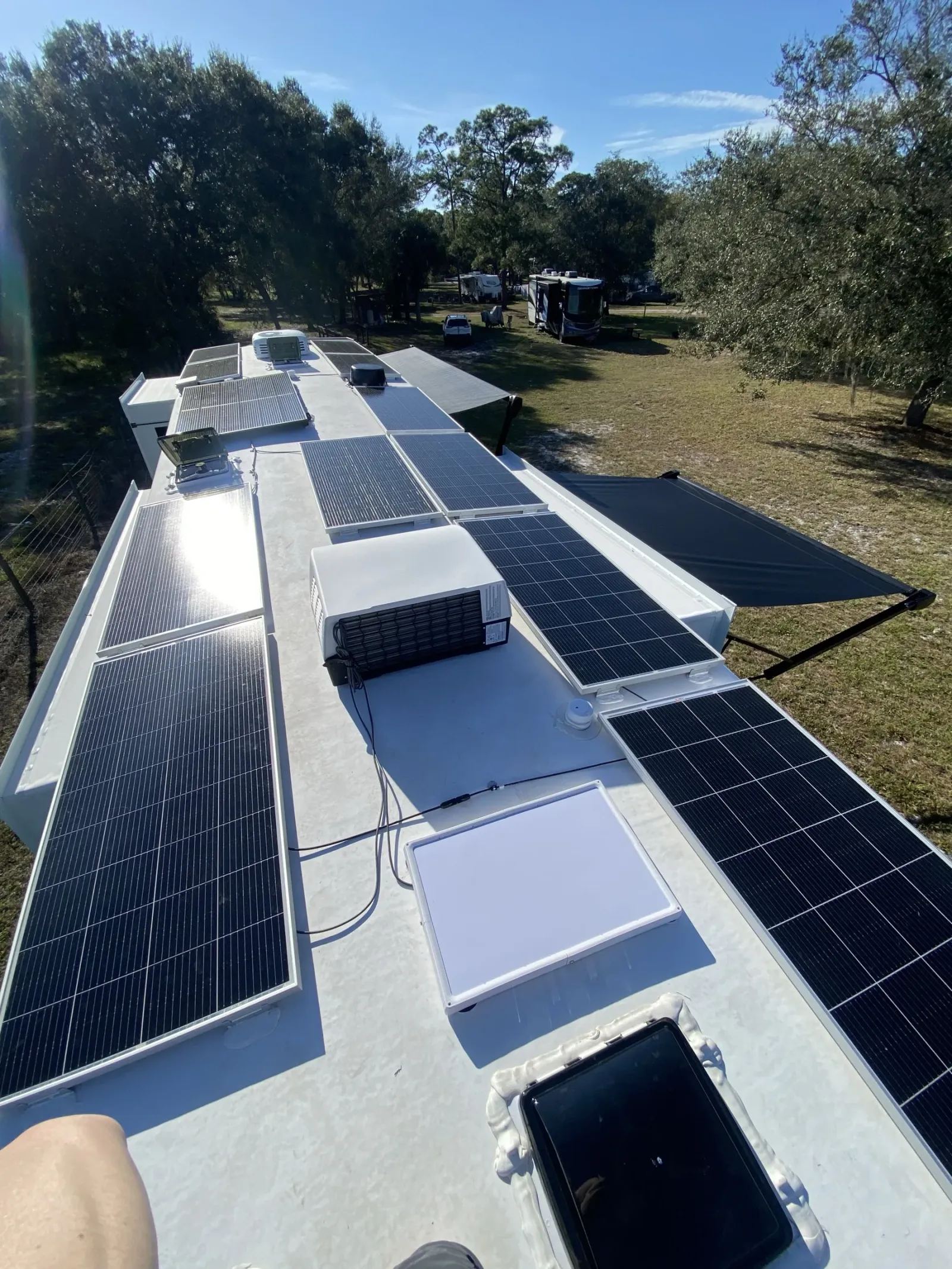Our Starlink flat-mounted on the RV roof, between the solar panels and the rear AC unit