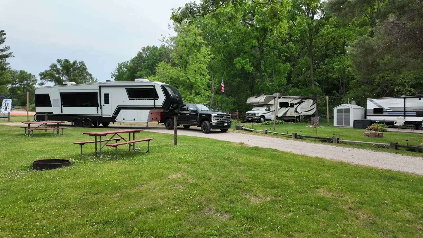 Our Ford F-350 and Brinkley fifth wheel stopped on the campground road beside the pull-through site that could not fit them