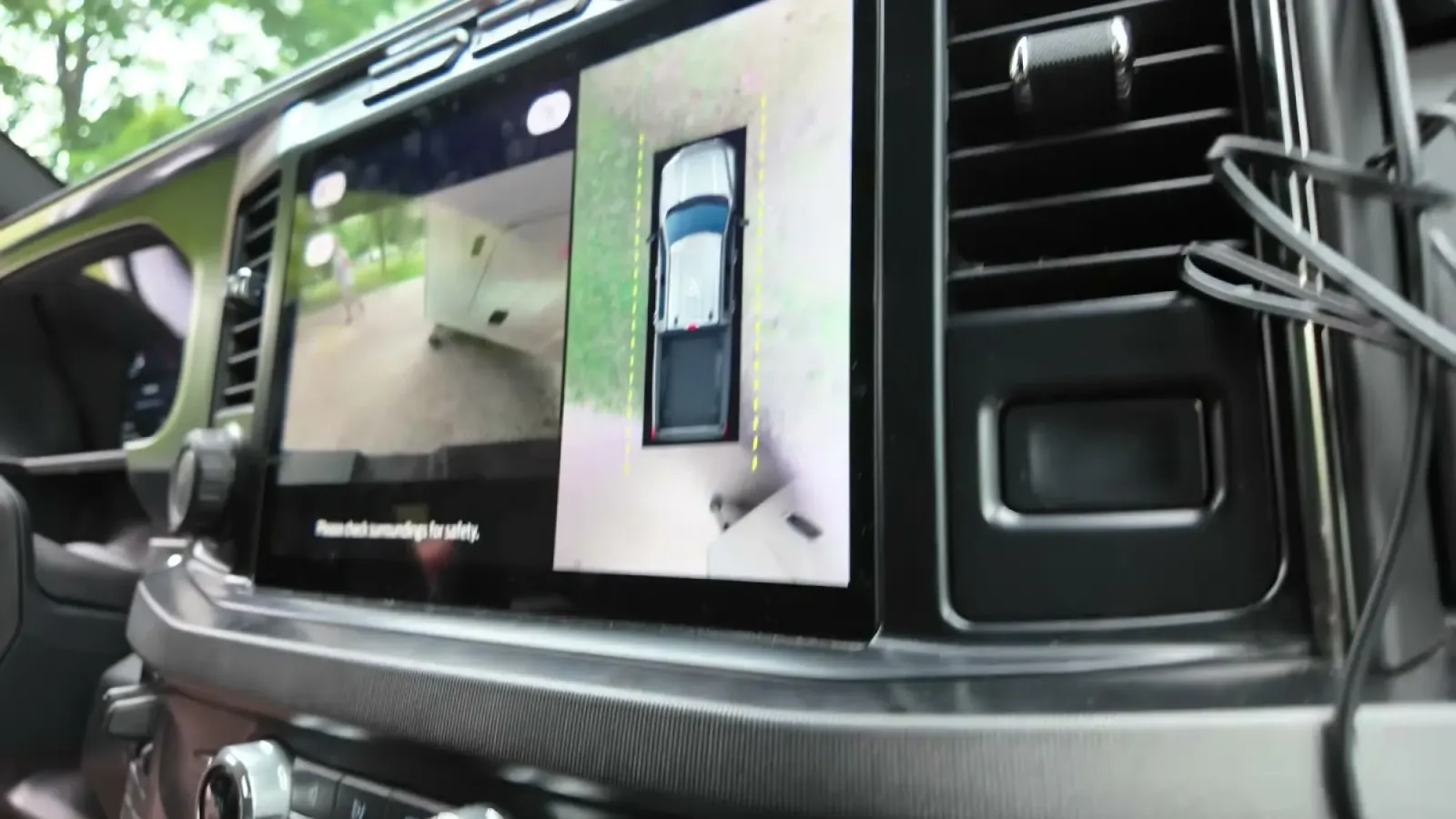 The truck's 360-degree camera view on the dash screen while backing the fifth wheel in from the site's exit end