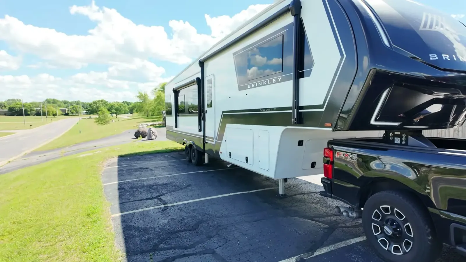 Our Brinkley fifth wheel and F-350 parked at the back of the barbecue restaurant's parking lot during a lunch stop
