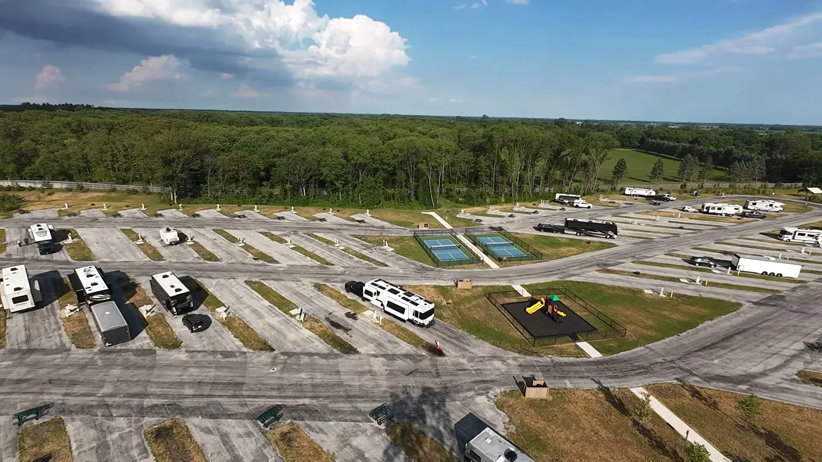 Drone view of the Love's RV Stop showing the rows of pull-through sites, tennis court, and playground