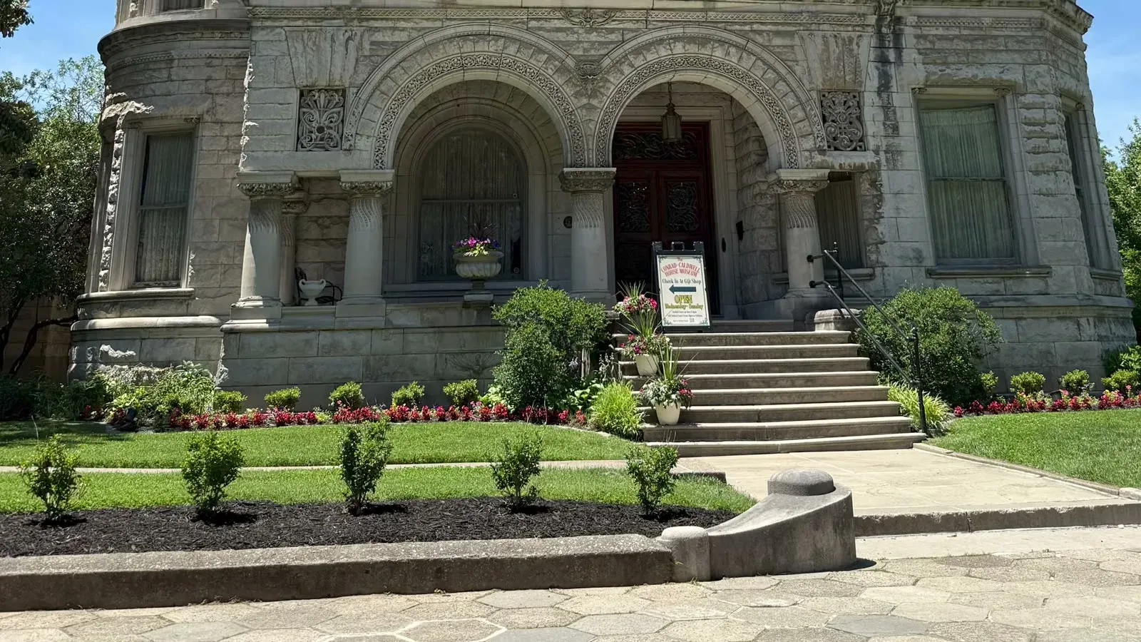 The carved stone entrance and front garden of the Conrad-Caldwell House Museum, the place locals call Conrad's Castle.