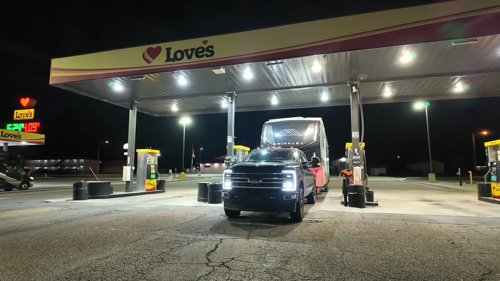 Our truck and Brinkley fifth wheel at a Love's fuel stop after dark