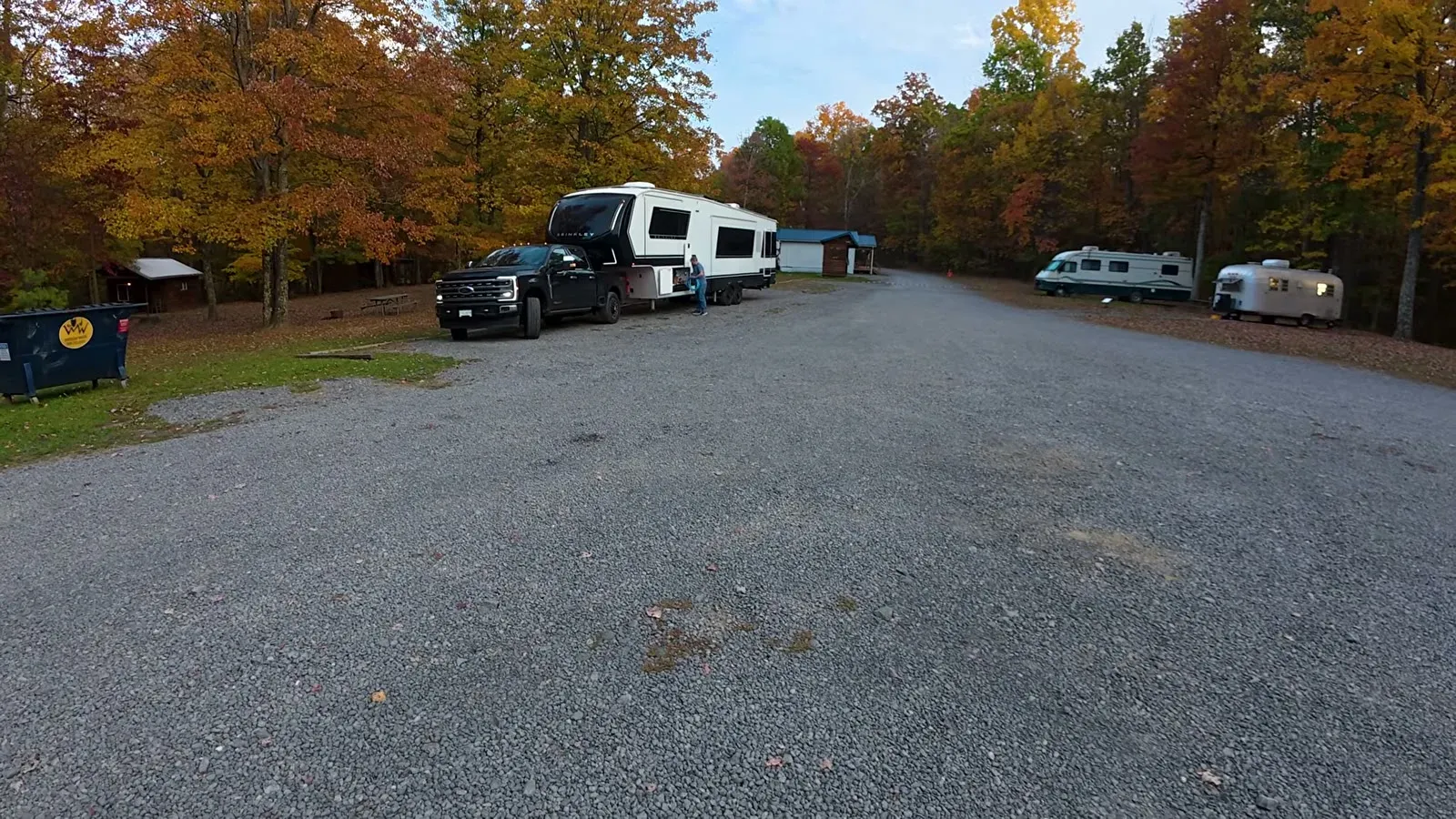 Our truck and fifth wheel sitting on the gravel campground road, surrounded by fall color in gorge country.