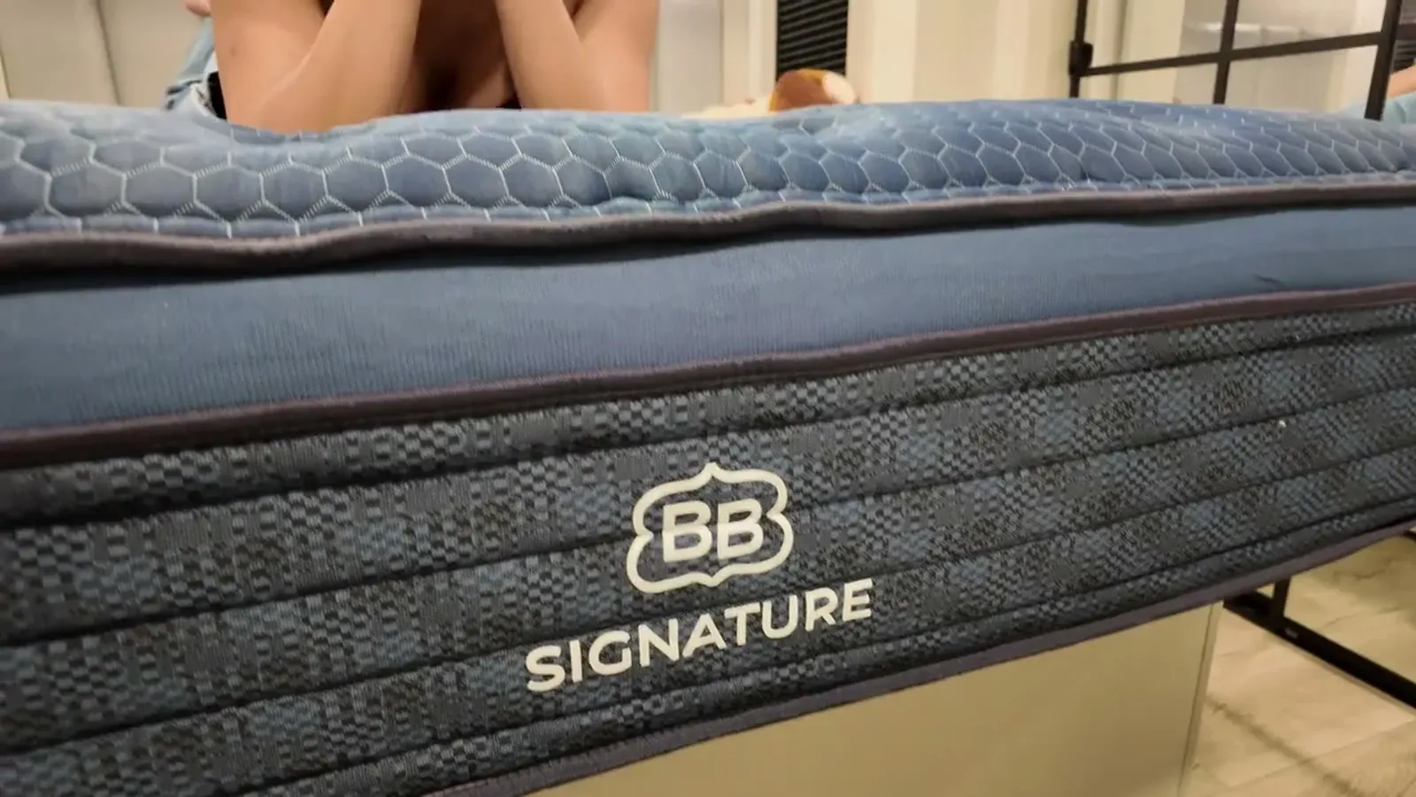 The BB Signature label from Brooklyn Bedding on the side band of the mattress, with the quilted top edge above it.